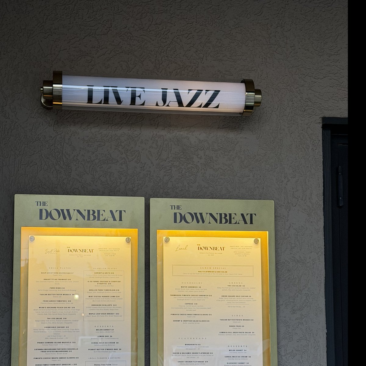 The LIVE JAZZ light over The Downbeat's menu boards outside the downtown Hickory jazz lounge